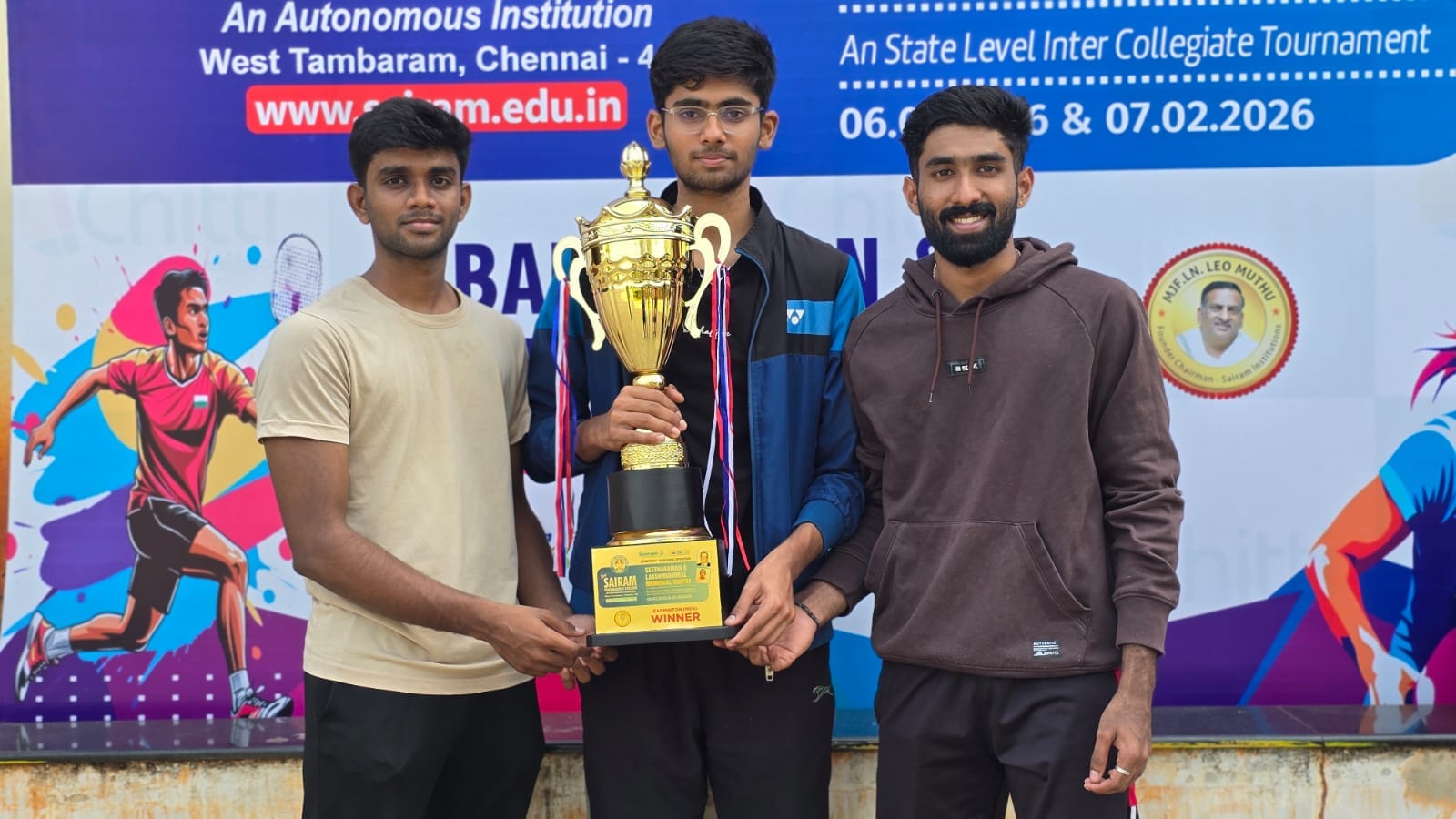 Anirudh with teammates receiving a badminton tournament trophy
