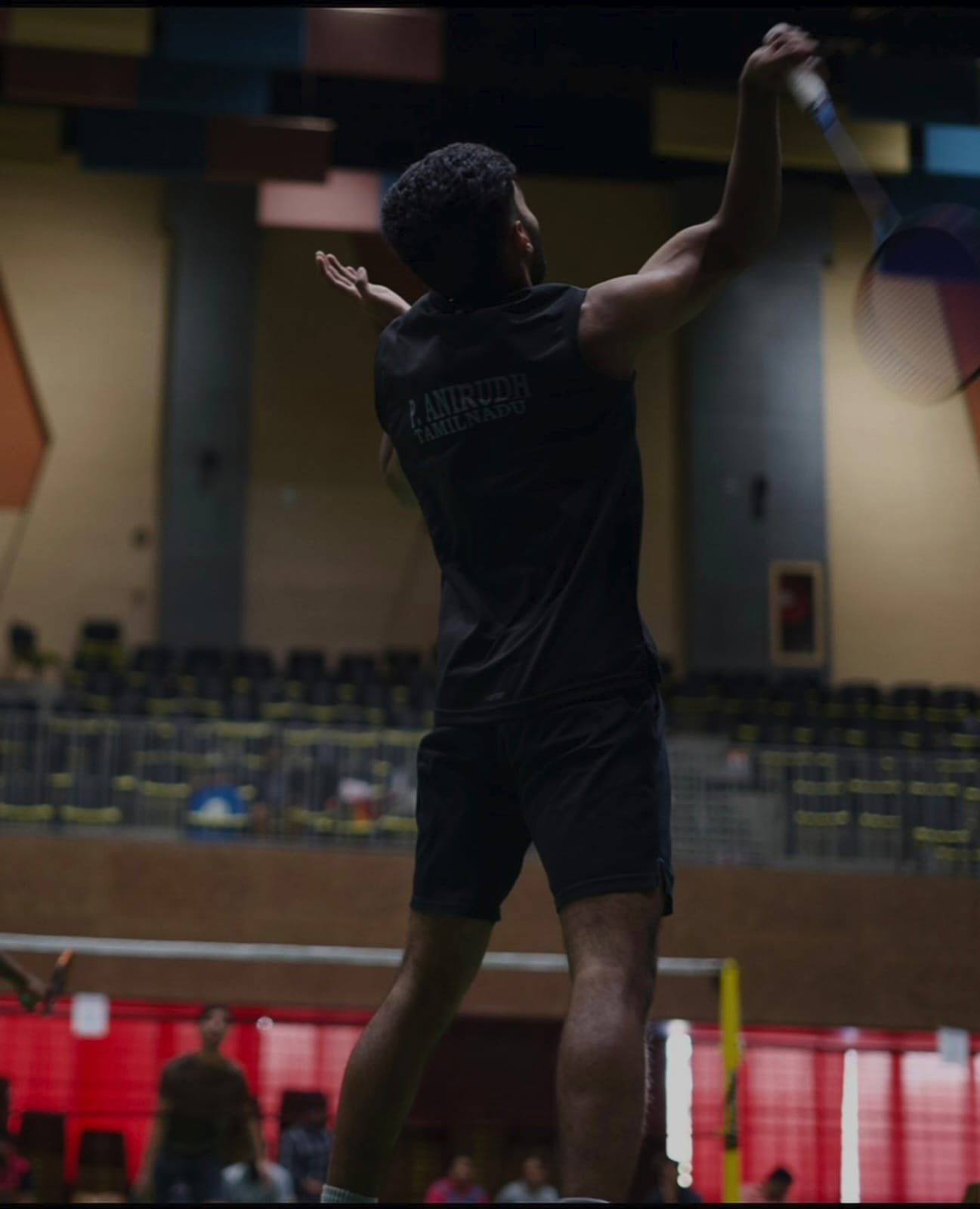 Anirudh playing a badminton shot